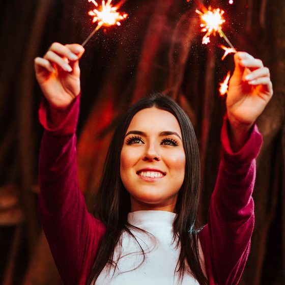 A guest holding sparklers overhead