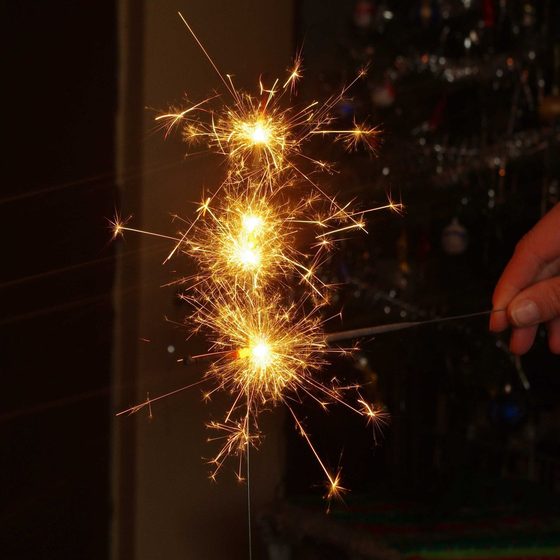 Guests holding sparklers on a dance floor